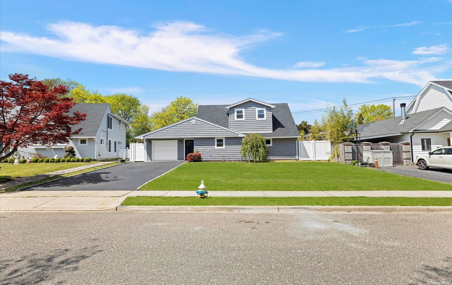 367 Blacksmith Road Levittown, NY 11756 - Photo 1 of 1 a front view of a house with a garden and trees