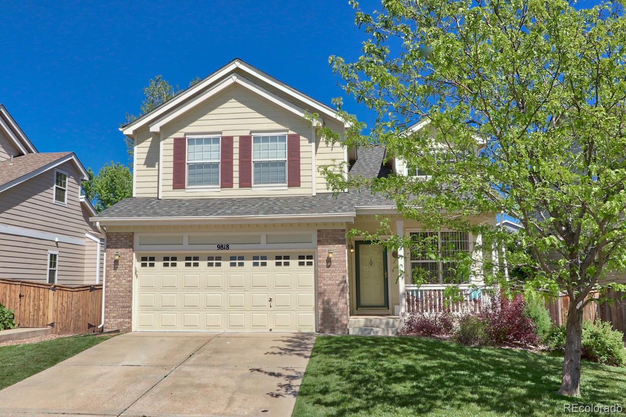 9818 Mulberry Way Highlands Ranch, CO 80129 - Photo 1 of 34 a front view of a house with a garden