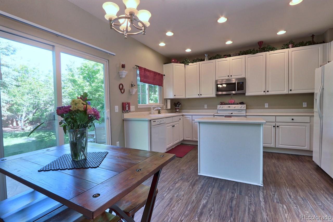 9818 Mulberry Way Highlands Ranch, CO 80129 - Photo 11 of 34 a kitchen with a table and chairs in it