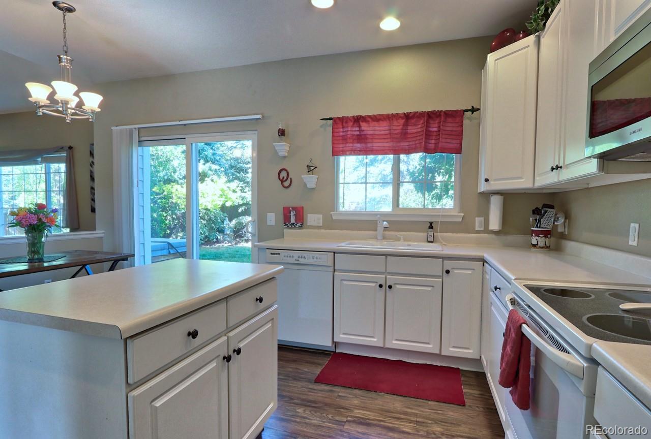 9818 Mulberry Way Highlands Ranch, CO 80129 - Photo 15 of 34 a kitchen with a sink stove and cabinets