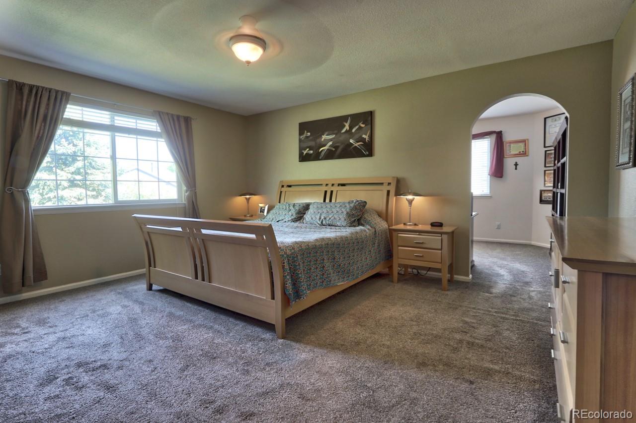 9818 Mulberry Way Highlands Ranch, CO 80129 - Photo 17 of 34 a bedroom with bed and a window