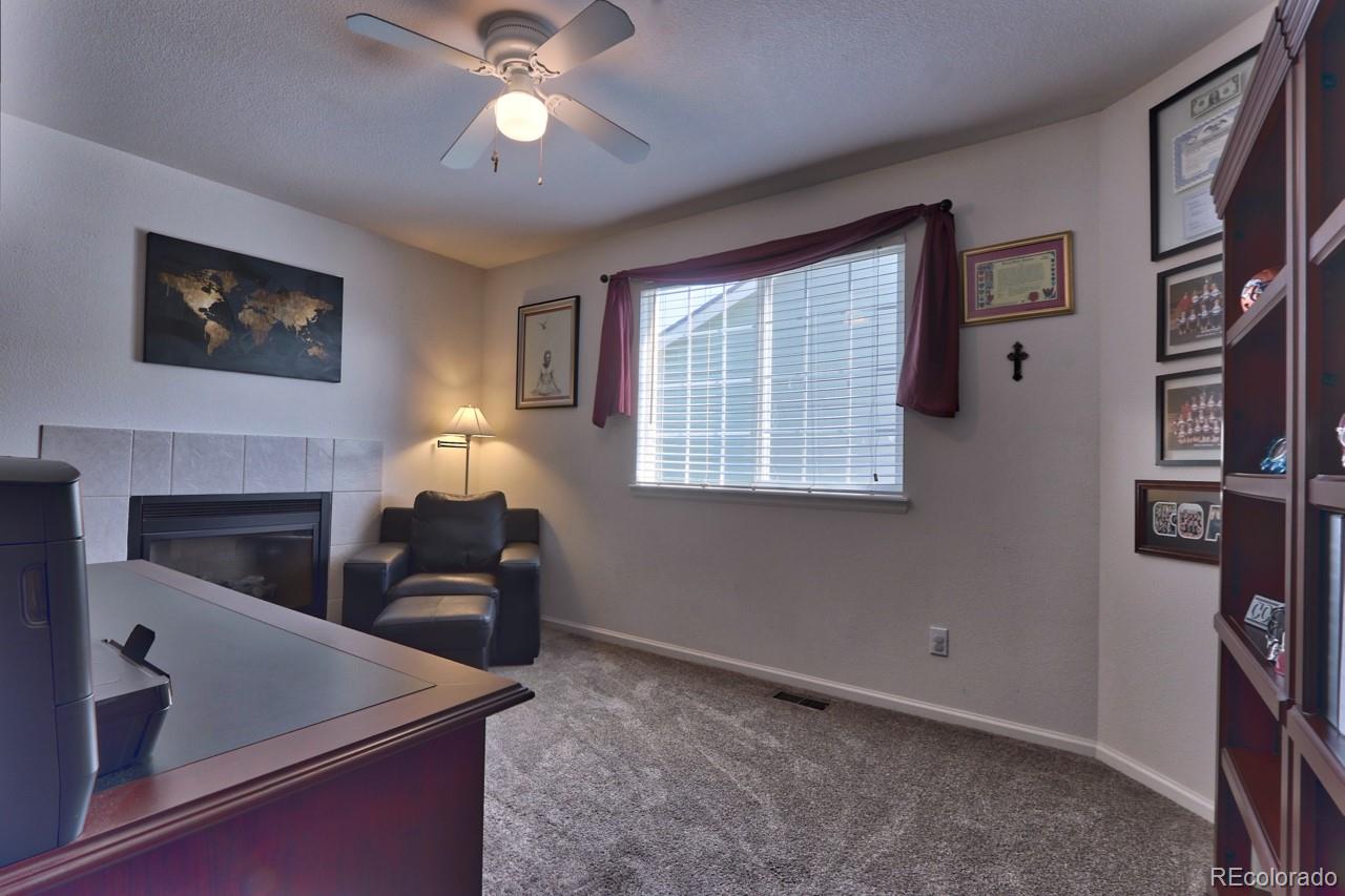 9818 Mulberry Way Highlands Ranch, CO 80129 - Photo 19 of 34 a living room with furniture and a chandelier