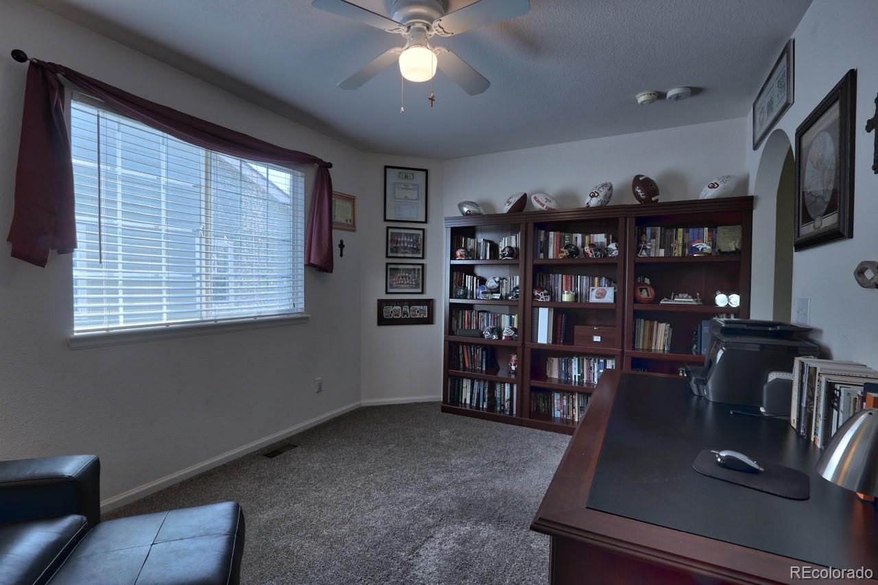 9818 Mulberry Way Highlands Ranch, CO 80129 - Photo 20 of 34 a view of a livingroom with furniture and a bookshelf