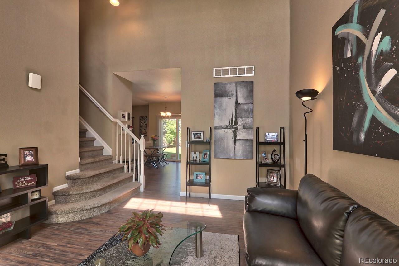 9818 Mulberry Way Highlands Ranch, CO 80129 - Photo 2 of 34 a living room with furniture and wooden floor
