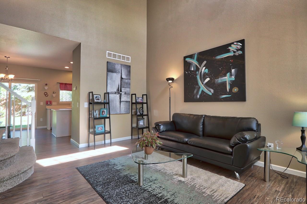 9818 Mulberry Way Highlands Ranch, CO 80129 - Photo 3 of 34 a living room with furniture and wooden floor