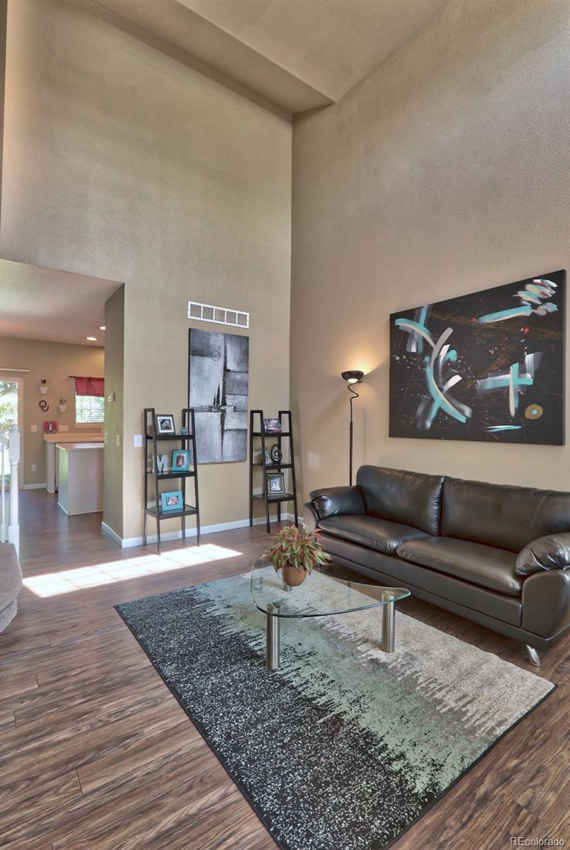 9818 Mulberry Way Highlands Ranch, CO 80129 - Photo 31 of 34 a living room with furniture and wooden floor
