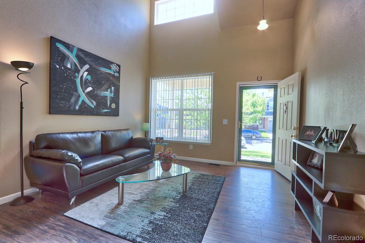 9818 Mulberry Way Highlands Ranch, CO 80129 - Photo 4 of 34 a living room with furniture and a flat screen tv