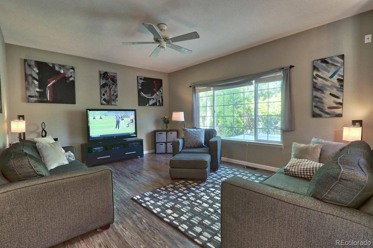 9818 Mulberry Way Highlands Ranch, CO 80129 - Photo 5 of 34 a living room with furniture and a flat screen tv