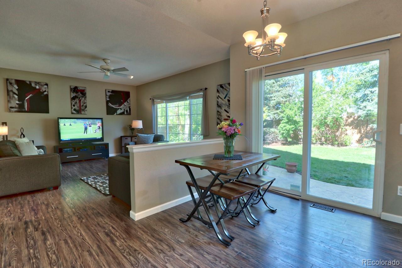 9818 Mulberry Way Highlands Ranch, CO 80129 - Photo 7 of 34 a view of a dining room with furniture a chandelier and wooden floor