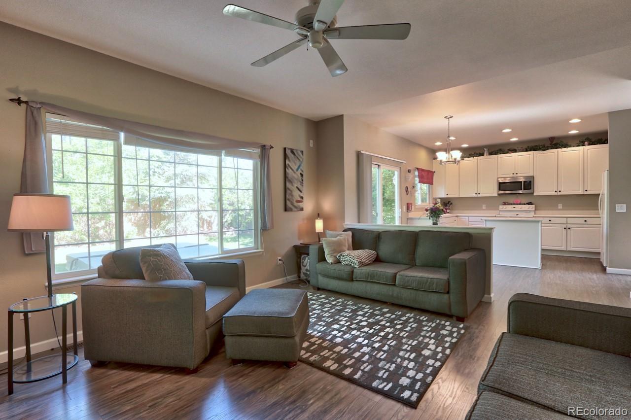 9818 Mulberry Way Highlands Ranch, CO 80129 - Photo 8 of 34 a living room with furniture and a large window