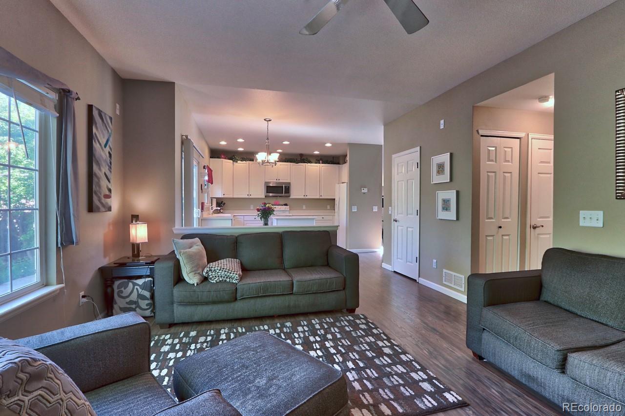 9818 Mulberry Way Highlands Ranch, CO 80129 - Photo 9 of 34 a living room with furniture and a rug
