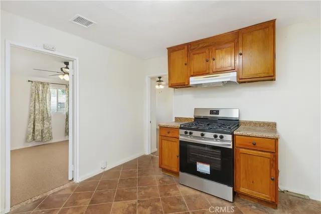a kitchen with stainless steel appliances granite countertop a stove and a microwave