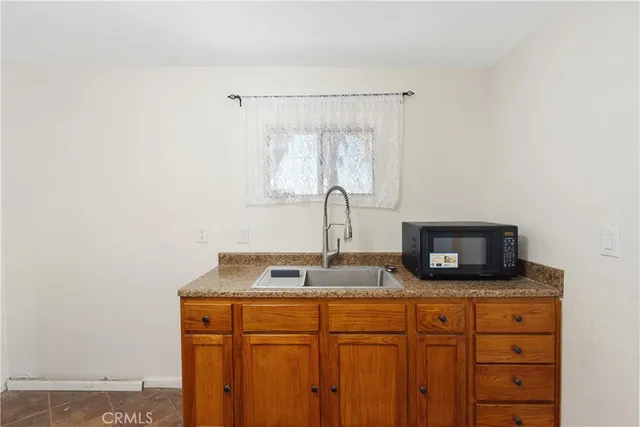 a kitchen with granite countertop a stove and a sink