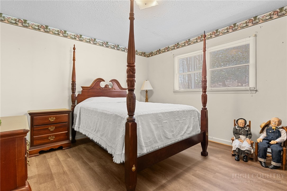 271 Quail Hollow Road Crumpler, NC 28617 - Photo 16 of 30 a bedroom with a bed dresser and a window