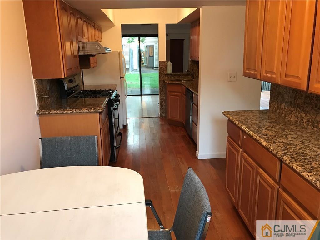 5807 Hana Road Edison, NJ 08817 - Photo 4 of 8 a kitchen with stainless steel appliances granite countertop a refrigerator a stove and a sink