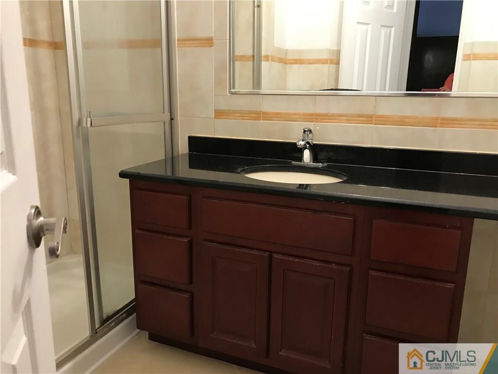 5807 Hana Road Edison, NJ 08817 - Photo 6 of 8 a bathroom with a sink and a mirror