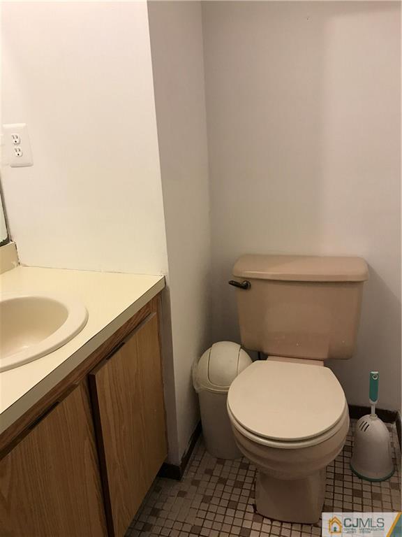 5807 Hana Road Edison, NJ 08817 - Photo 7 of 8 a white toilet sitting next to a sink