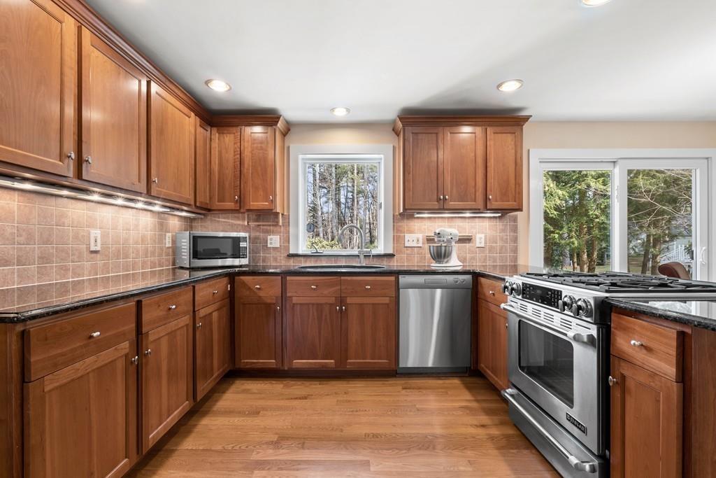 14 Ridge Hill Road Sudbury, MA 01776 - Photo 12 of 34 a kitchen with stainless steel appliances granite countertop a stove a sink and a microwave