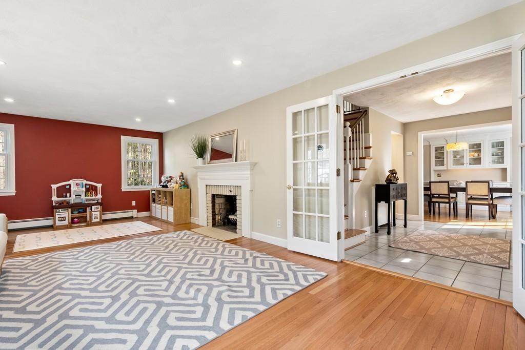 14 Ridge Hill Road Sudbury, MA 01776 - Photo 8 of 34 a living room with furniture a fireplace and a flat screen tv