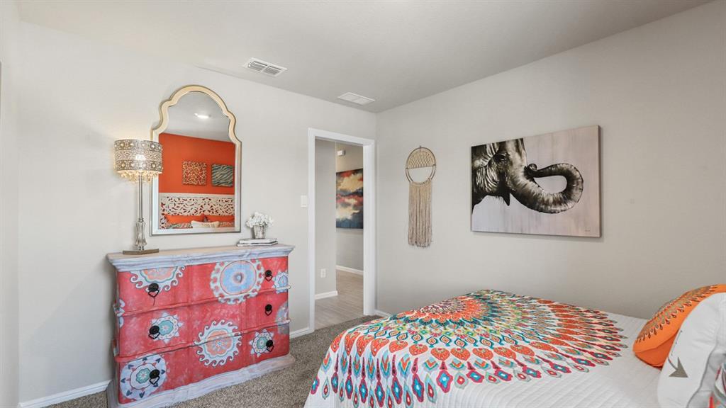 16404 Rosella Lane Justin, TX 76247 - Photo 26 of 38 a bedroom with a bed and a painting on the wall