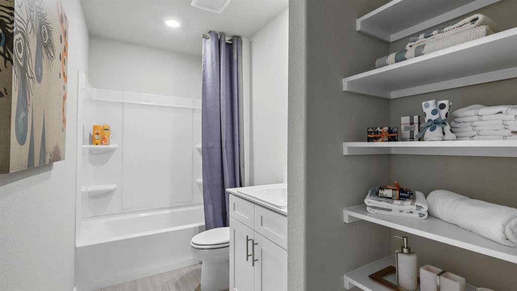 16404 Rosella Lane Justin, TX 76247 - Photo 28 of 38 a bathroom with a bathtub and sink