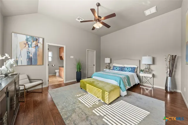 a bedroom with a bed and wooden floor