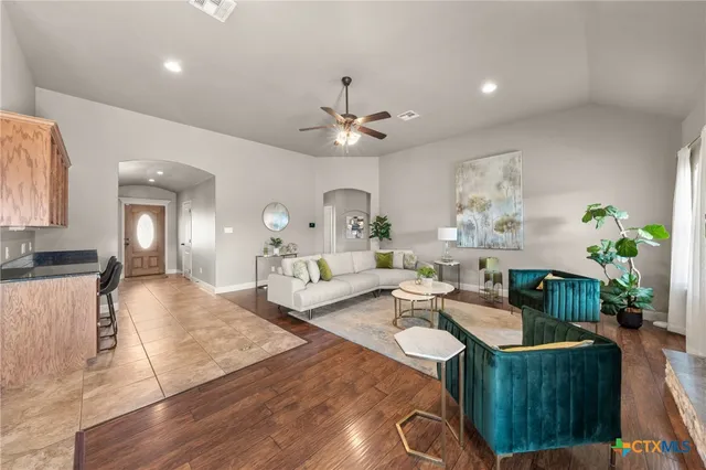a living room with fireplace furniture and a chandelier