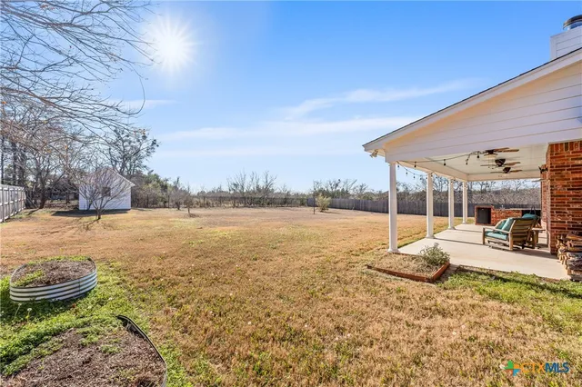 a view of a swimming pool and lounge chairs