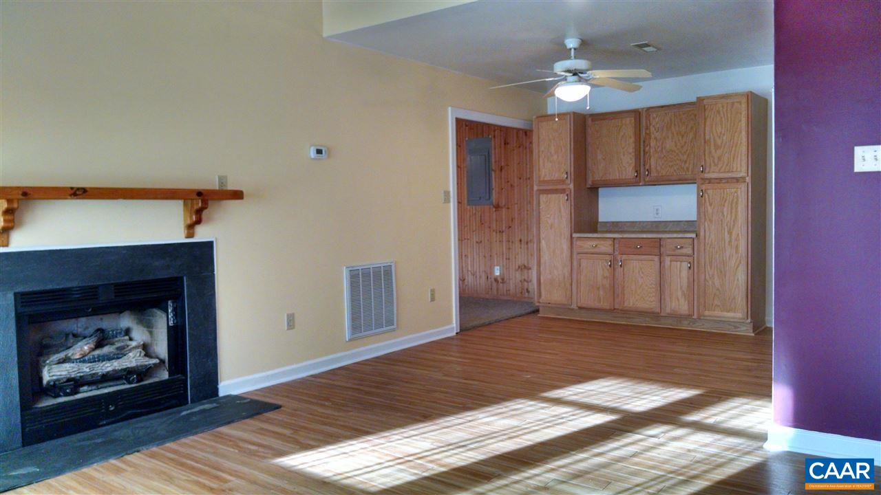 699 Carnation Road Ruckersville, VA 22968 - Photo 5 of 40 a view of a livingroom with a fireplace a ceiling fan and wooden floor