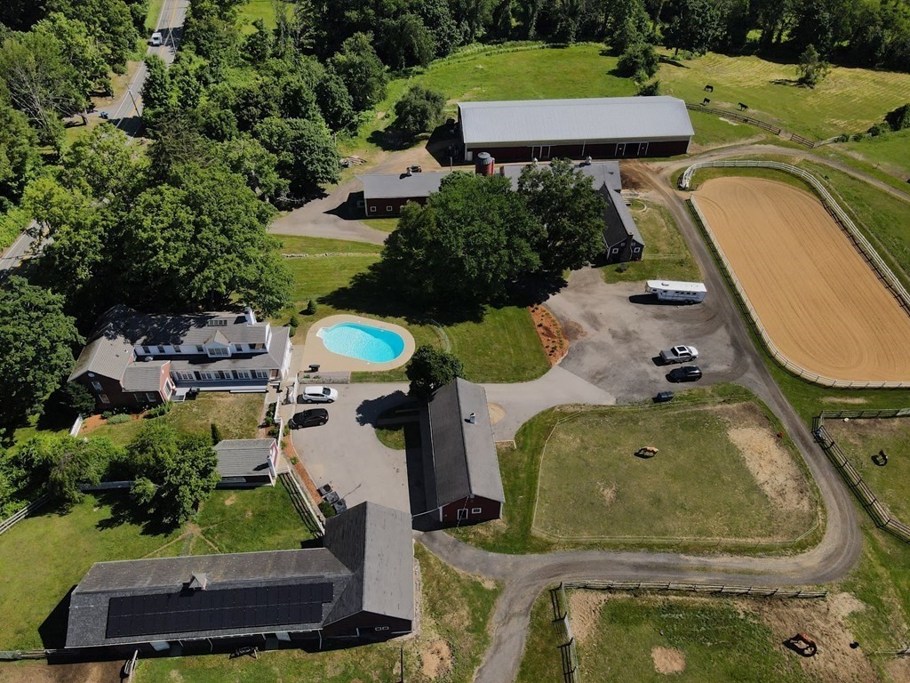 64 Fiskdale Road Brookfield, MA 01506 - Photo 1 of 42 an aerial view of a house with a swimming pool and a yard