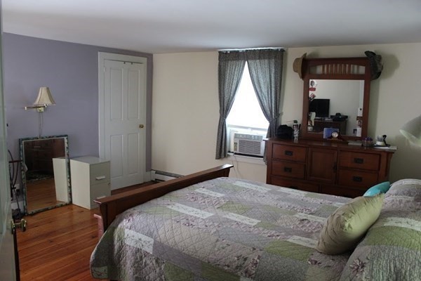 64 Fiskdale Road Brookfield, MA 01506 - Photo 24 of 42 a bedroom with a bed and wooden floor