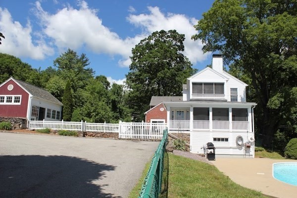 64 Fiskdale Road Brookfield, MA 01506 - Photo 6 of 42 a front view of a house with a garden