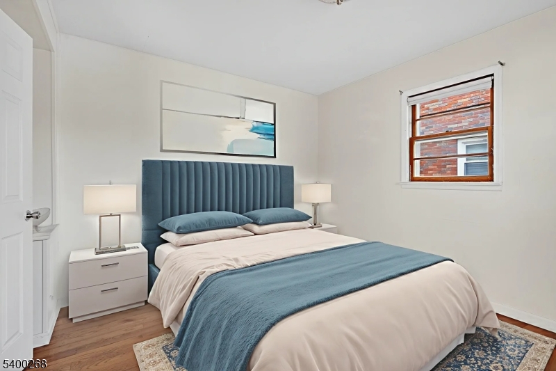 44 Liberty Street Clifton, NJ 07013 - Photo 7 of 11 a bedroom with a bed and a window