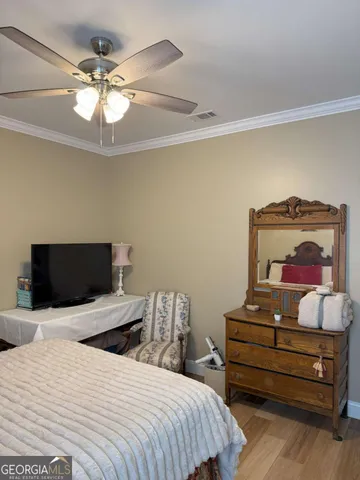 a bedroom with a bed and a mirror