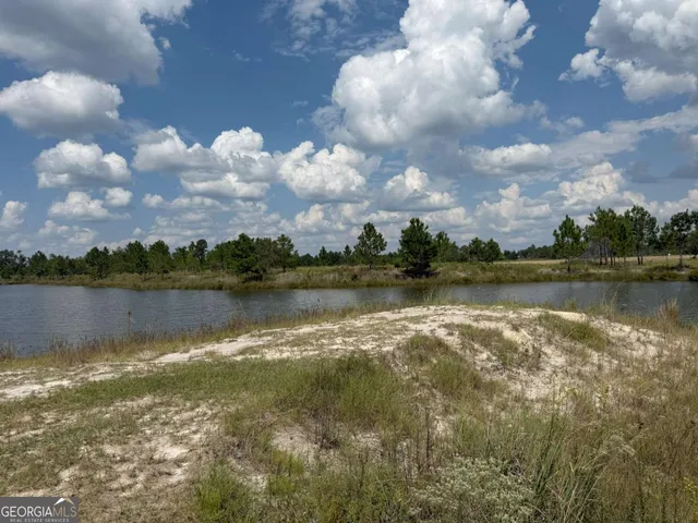 a view of a lake with houses in the back