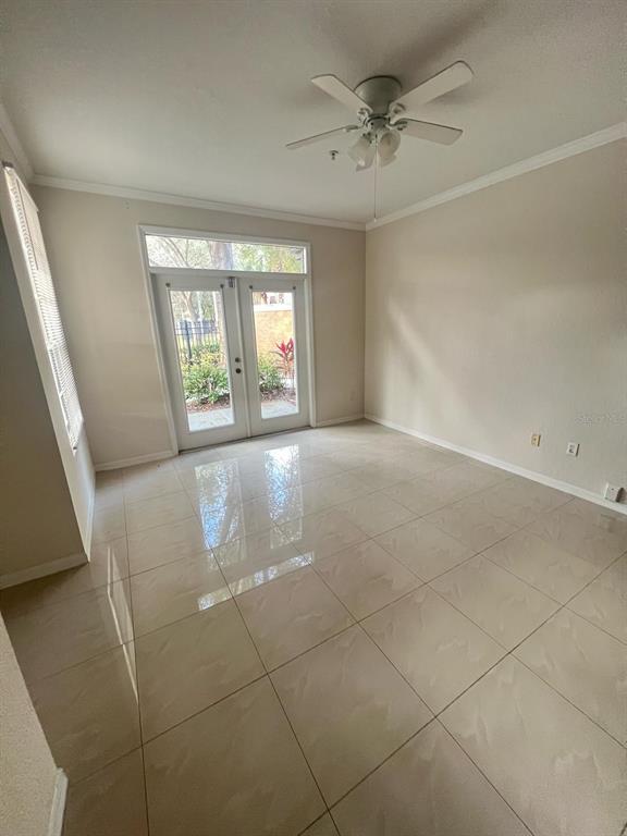 6368 Raleigh Street, Unit 1803 Orlando, FL 32835 - Photo 5 of 14 an empty room with windows and ceiling fan
