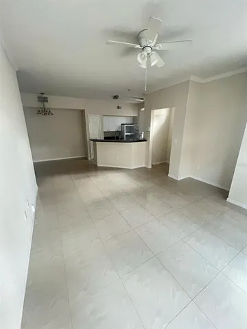 an empty room with a ceiling fan and entryway