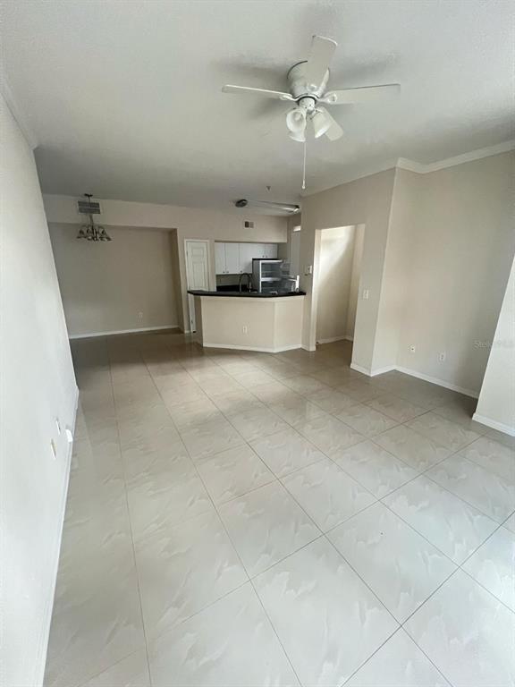 6368 Raleigh Street, Unit 1803 Orlando, FL 32835 - Photo 6 of 14 an empty room with a ceiling fan and entryway