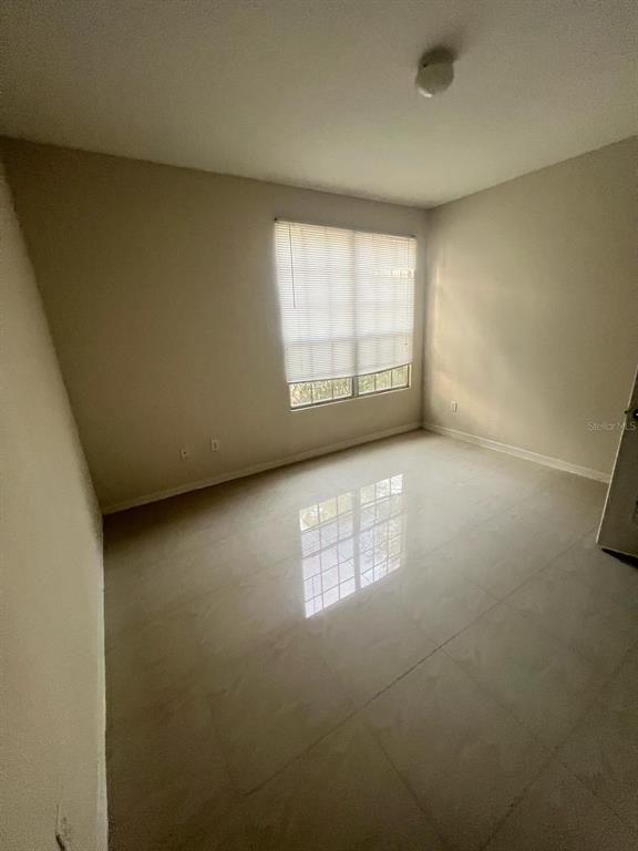 6368 Raleigh Street, Unit 1803 Orlando, FL 32835 - Photo 8 of 14 an empty room with windows