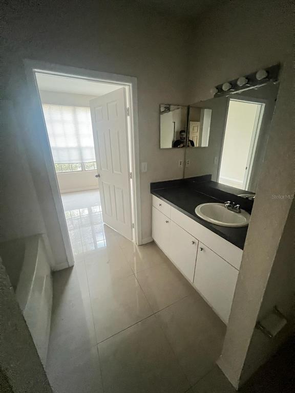 6368 Raleigh Street, Unit 1803 Orlando, FL 32835 - Photo 10 of 14 a kitchen with a sink and a stove top oven