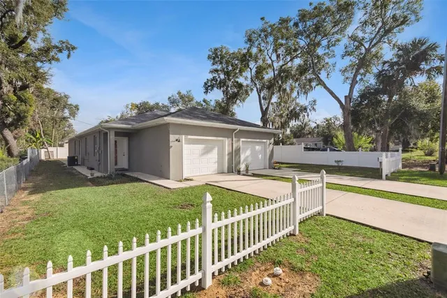 a view of a house with backyard and sitting area