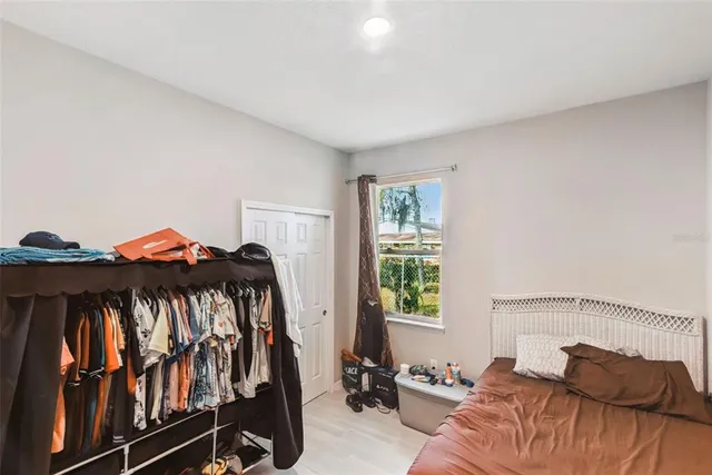 a bedroom with a bed and a window