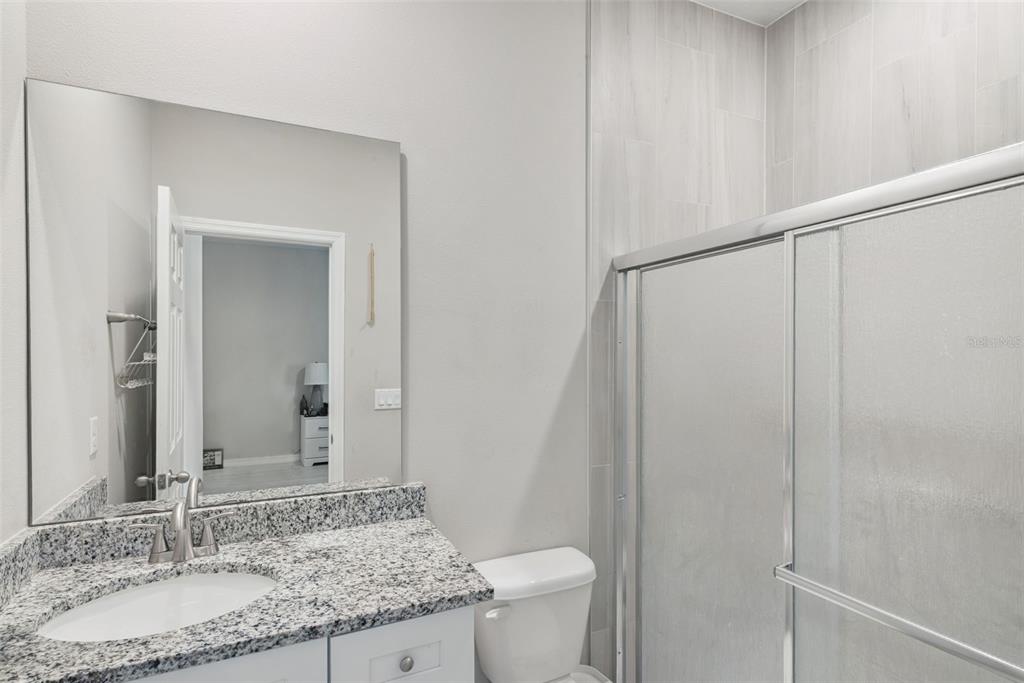 1021 Titcomb Street Eustis, FL 32726 - Photo 14 of 40 a bathroom with a granite countertop sink and a mirror