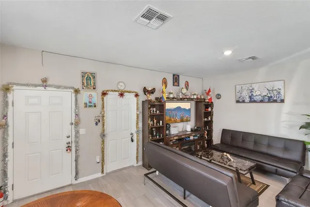 a kitchen with granite countertop a refrigerator and a stove top oven
