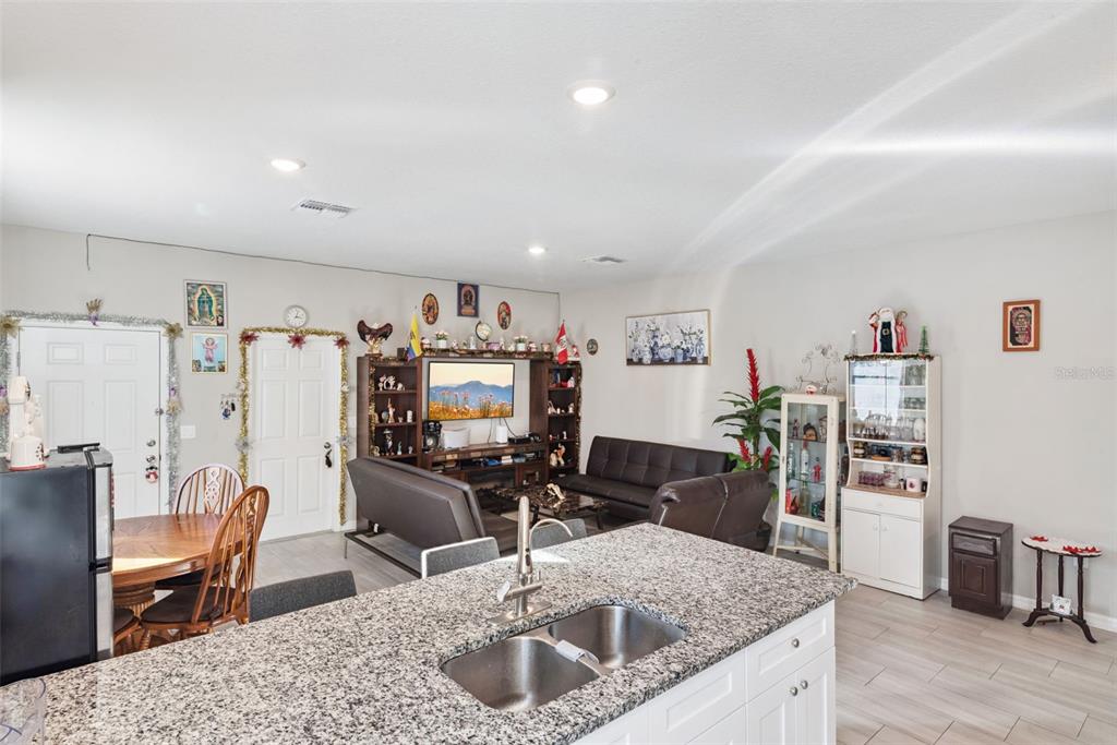 1021 Titcomb Street Eustis, FL 32726 - Photo 24 of 40 a kitchen with stainless steel appliances granite countertop a sink stove and refrigerator