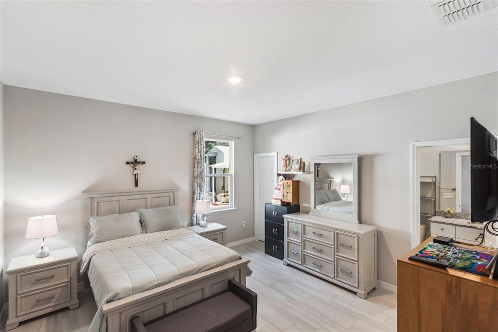 1021 Titcomb Street Eustis, FL 32726 - Photo 27 of 40 a bedroom with a bed and a flat screen tv