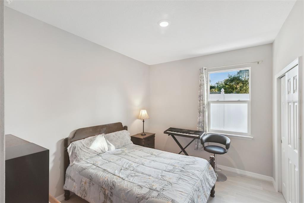 1021 Titcomb Street Eustis, FL 32726 - Photo 28 of 40 a bedroom with a bed and a window
