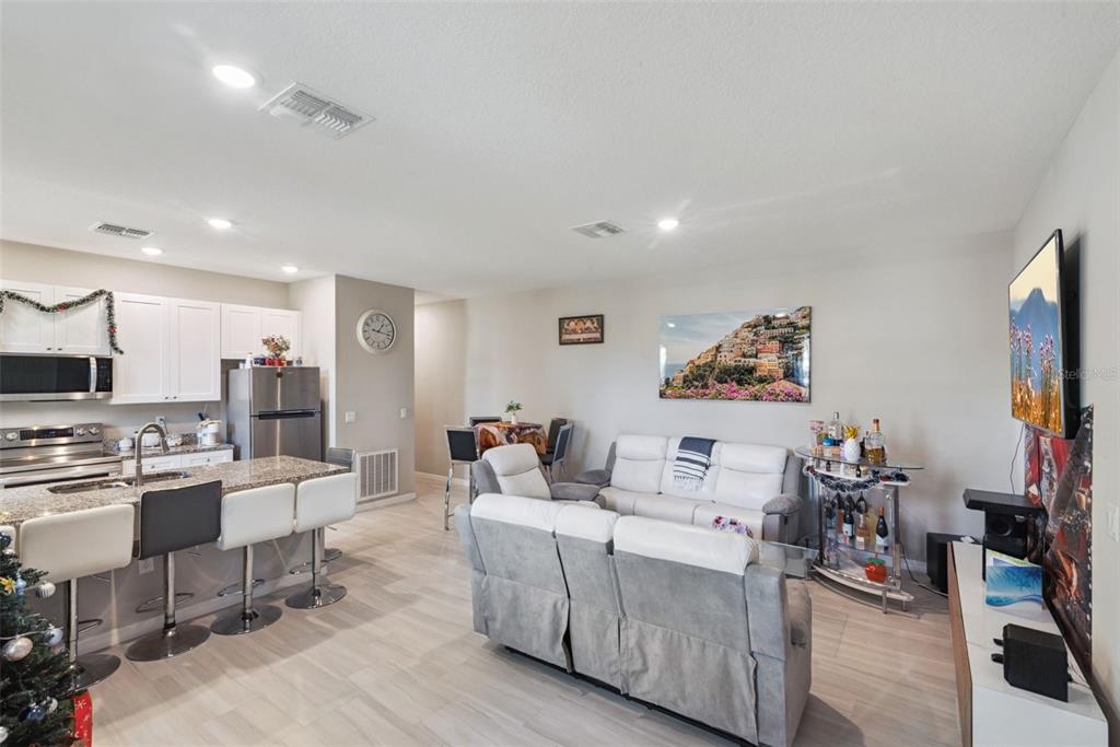 1021 Titcomb Street Eustis, FL 32726 - Photo 3 of 40 a living room with furniture and a flat screen tv