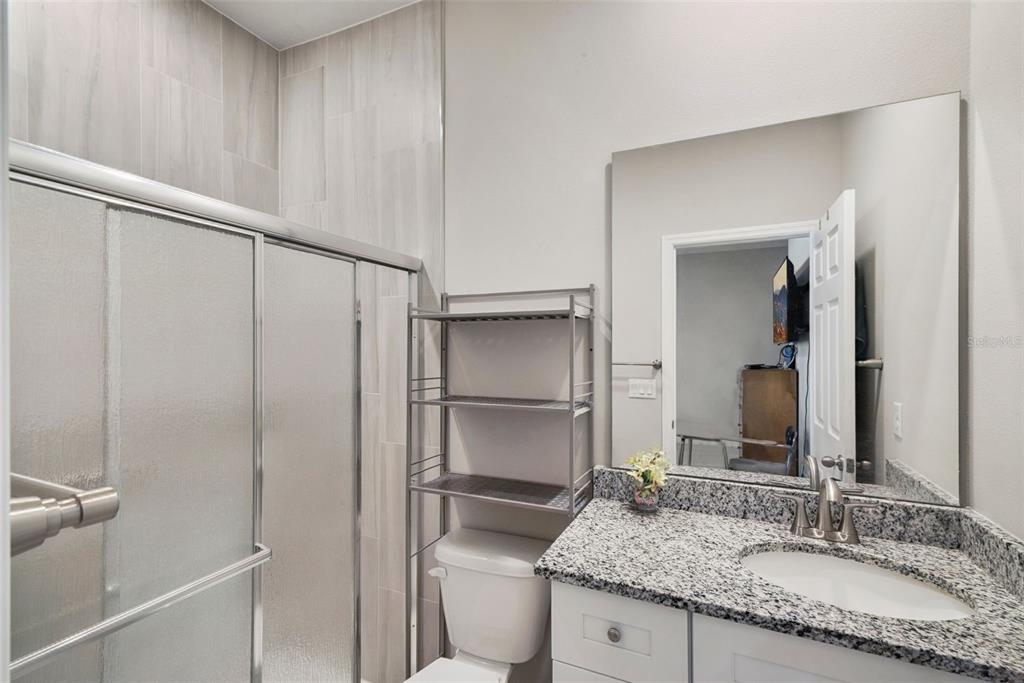 1021 Titcomb Street Eustis, FL 32726 - Photo 31 of 40 a bathroom with a granite countertop sink and a mirror