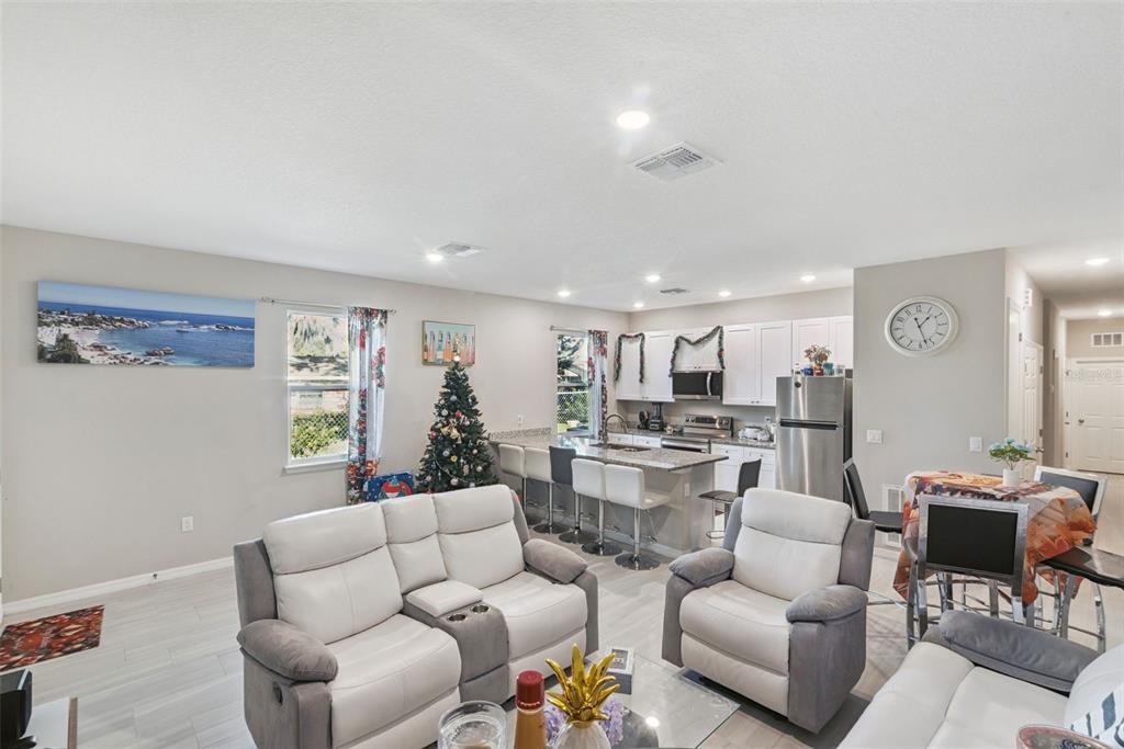 1021 Titcomb Street Eustis, FL 32726 - Photo 5 of 40 a living room with furniture kitchen view and a window